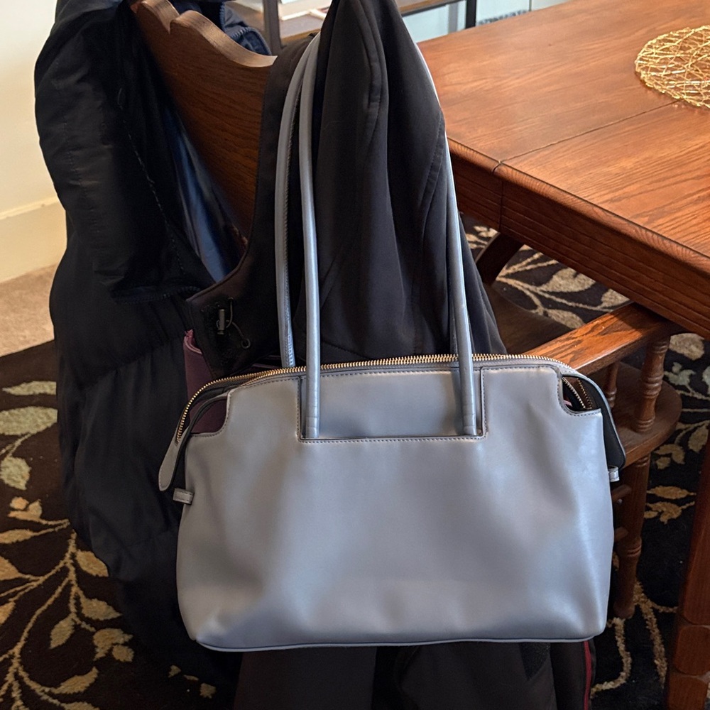 Blue handbag with zipper and pockets